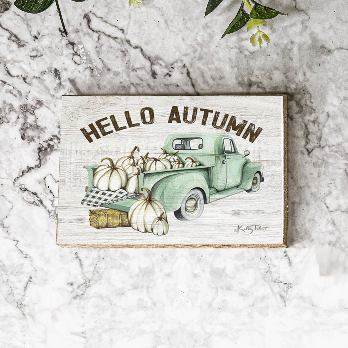 Hello Autumn teal truck sign on white marble with greenery