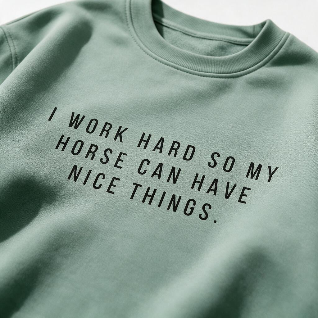 Close-up of the black I Work Hard So My Horse Can Have Nice Things print on the sweatshirt
