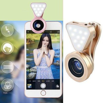 Gold clip-on selfie lens with LED light brightening a phone photo