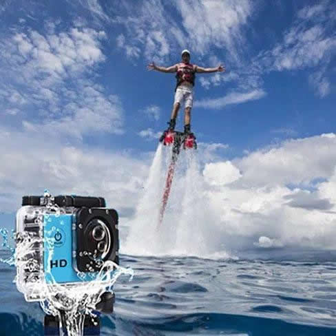 Blue action camera splashed with water, flyboarder behind