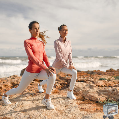 Action camera filming two women doing lunges on a beach