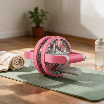 Pink ab roller wheel on a sage yoga mat in a home workout corner