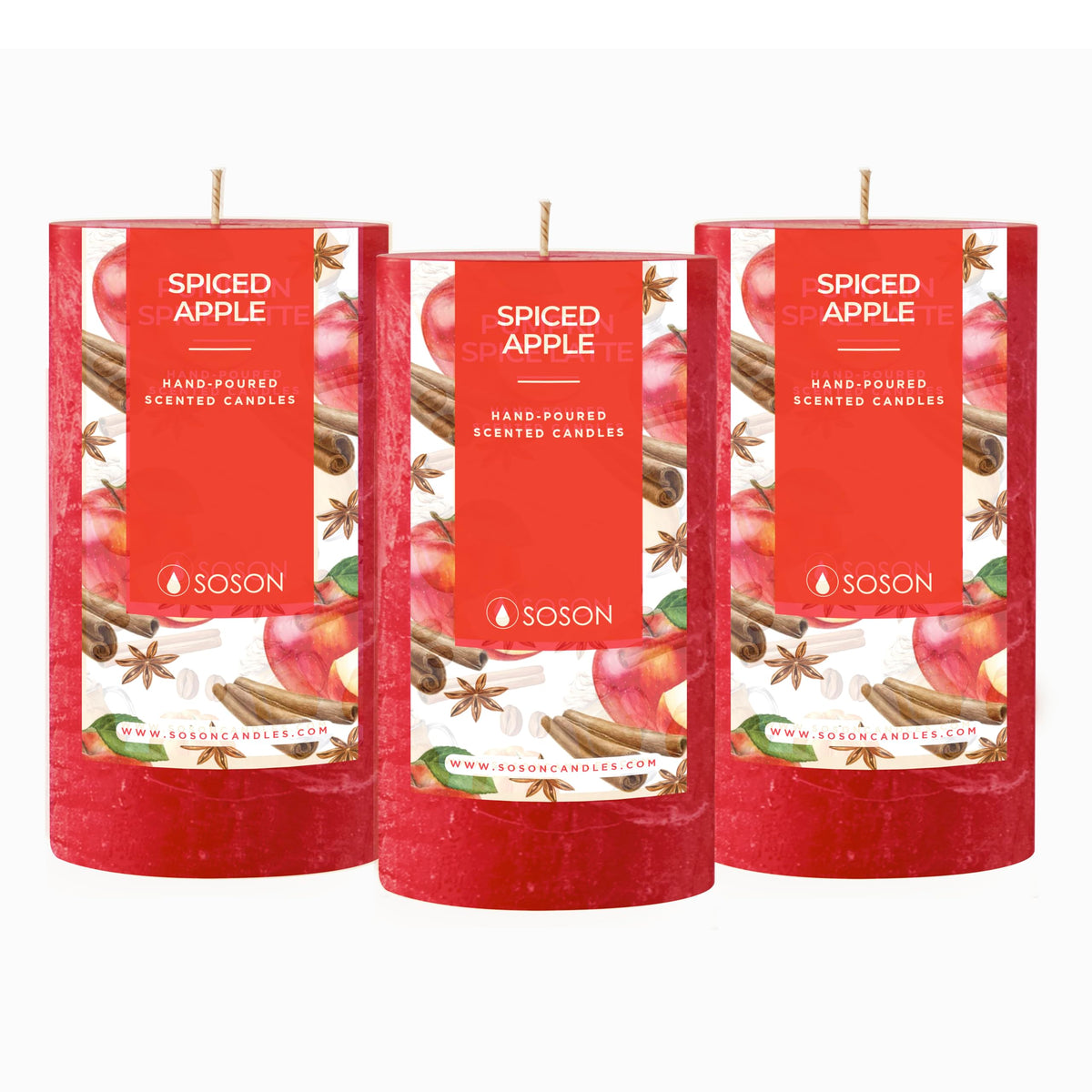 Set of 3 red Spiced Apple scented pillar candles on white