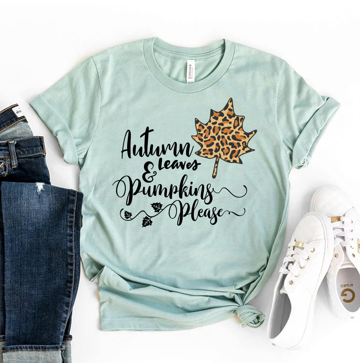Sage Autumn Leaves and Pumpkins Please t-shirt with a leopard leaf, flat lay with jeans