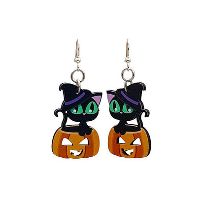 Black cat sitting on jack-o-lantern dangle earrings on white