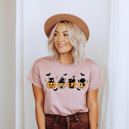 Woman in a hat wearing the pink black cat pumpkin Halloween t-shirt
