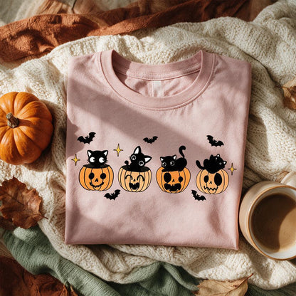 Pink black cat pumpkin Halloween t-shirt folded on a cream knit blanket with a mini pumpkin and coffee