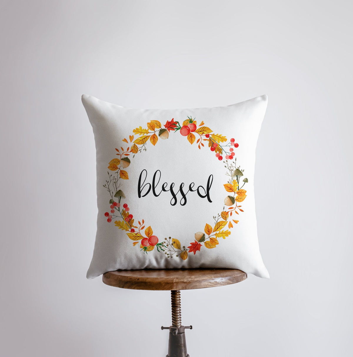 Blessed fall wreath throw pillow on a wooden stool
