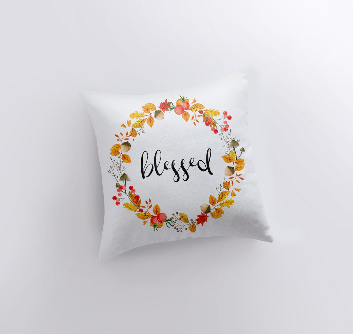 Blessed throw pillow with a watercolor autumn leaf and berry wreath on white