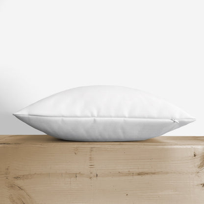 Blessed throw pillow lying flat on a wooden shelf, side profile