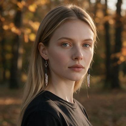 Woman wearing the bloody chef's knife dangle earrings in an autumn forest