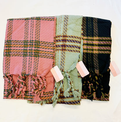 Braided fringe plaid scarves in pink, sage and black laid side by side
