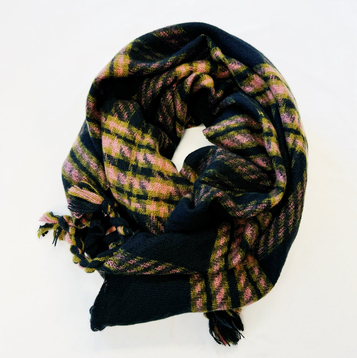 Black and pink plaid scarf with braided fringe, loosely folded on white