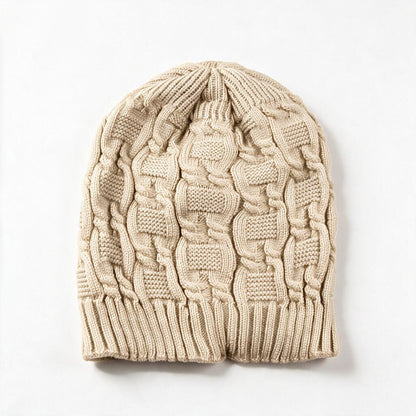Cable knit slouchy beanie in beige on a white background