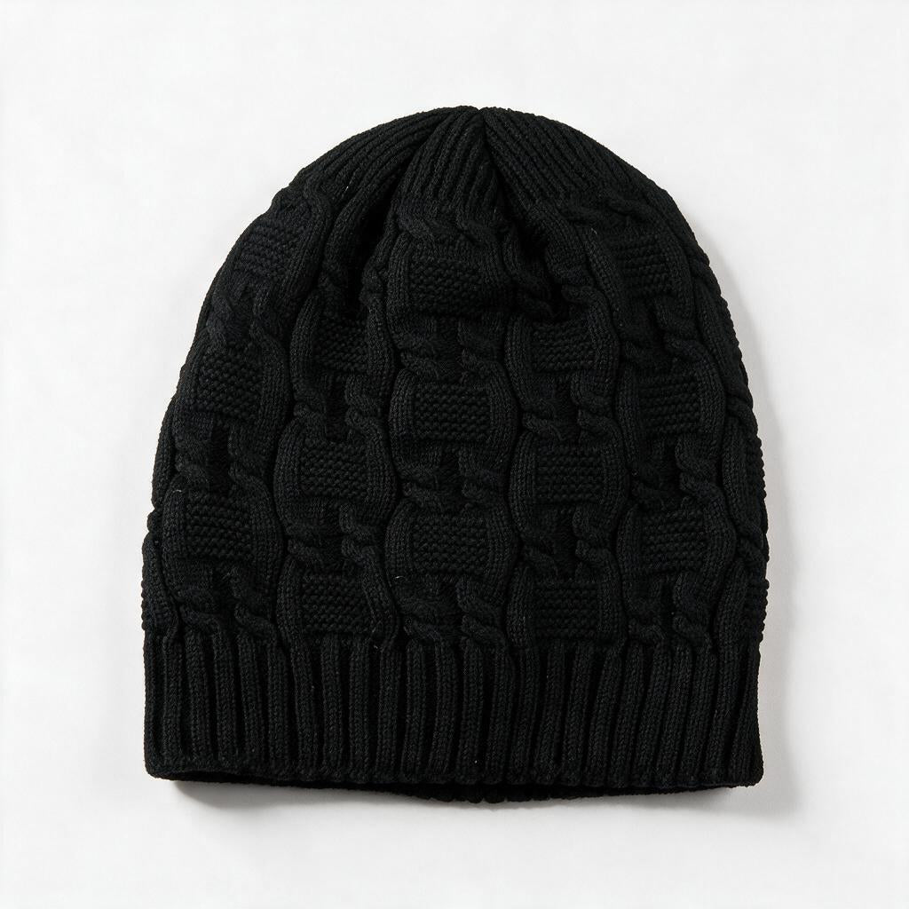 Cable knit slouchy beanie in black on a white background