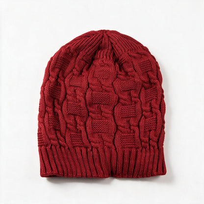 Cable knit slouchy beanie in jujube red on a white background