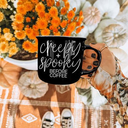 Creepy and Spooky mug held over orange mums and white pumpkins