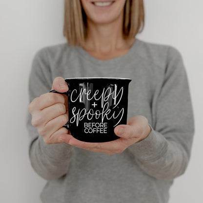 Woman in a gray sweater holding the Creepy and Spooky Before Coffee mug