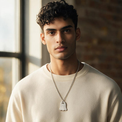 Man wearing the silver ghost pendant on a Cuban chain with a cream sweater