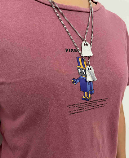 Cute ghost necklace worn layered over a red t-shirt