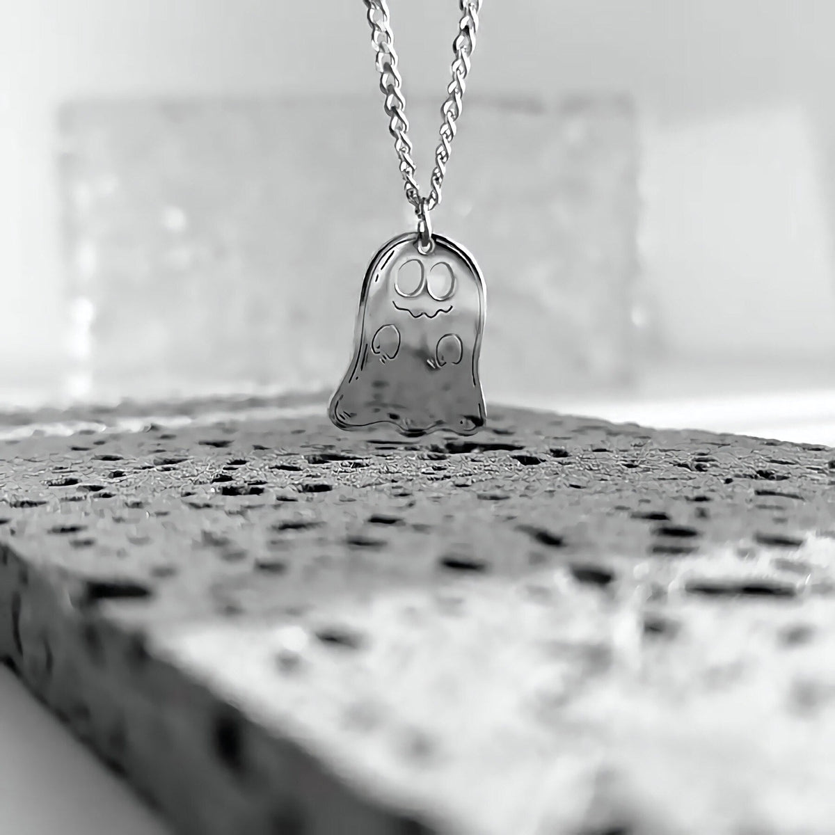 Close-up of the silver smiling ghost pendant