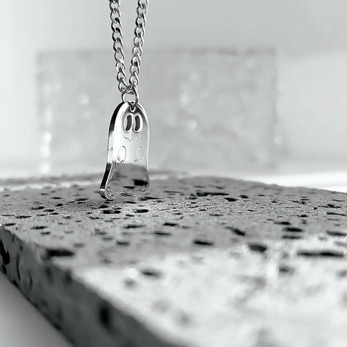 Side view of the silver ghost pendant on its chain