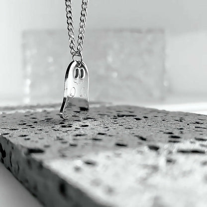 Side view of the silver ghost pendant on its chain