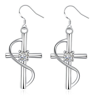 Silver cross drop earrings with a swirl and crystal center on white