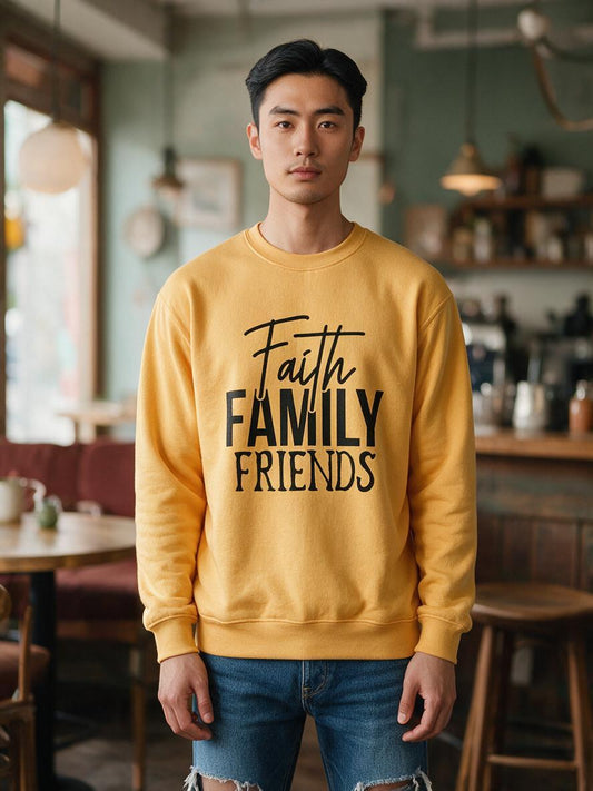 Man wearing the gold Faith Family Friends crewneck sweatshirt in a cafe