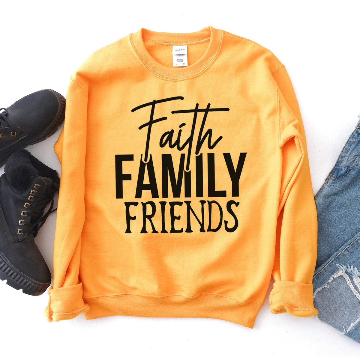 Gold Faith Family Friends sweatshirt flat lay with jeans and boots