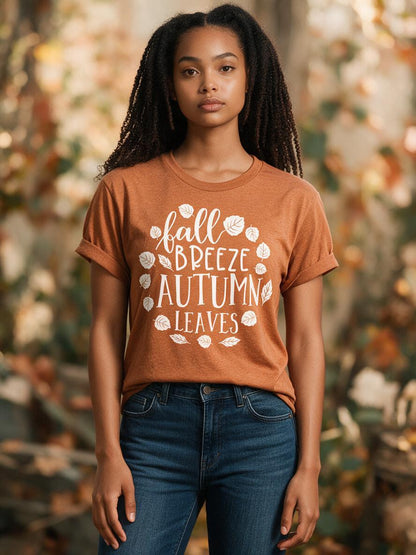 Woman wearing the rust Fall Breeze Autumn Leaves t-shirt with jeans in autumn light