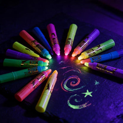 Neon face paint crayons glowing under blacklight with drawn swirls and stars on dark slate