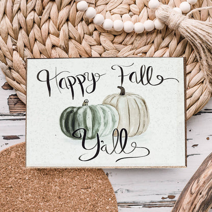 Close-up of the Happy Fall Y'all sign with sage and cream painted pumpkins and black script lettering
