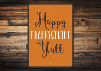 Orange Happy Thanksgiving Y'all metal sign on a rustic wood plank wall