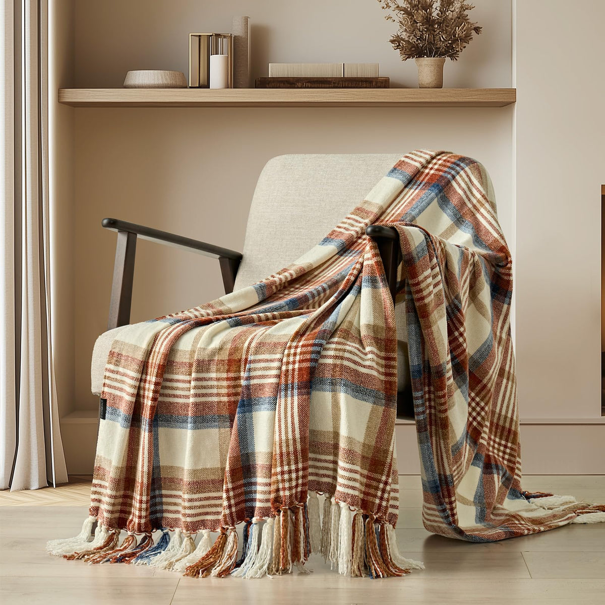 Harvest plaid chenille throw with tassels draped over a cream accent chair