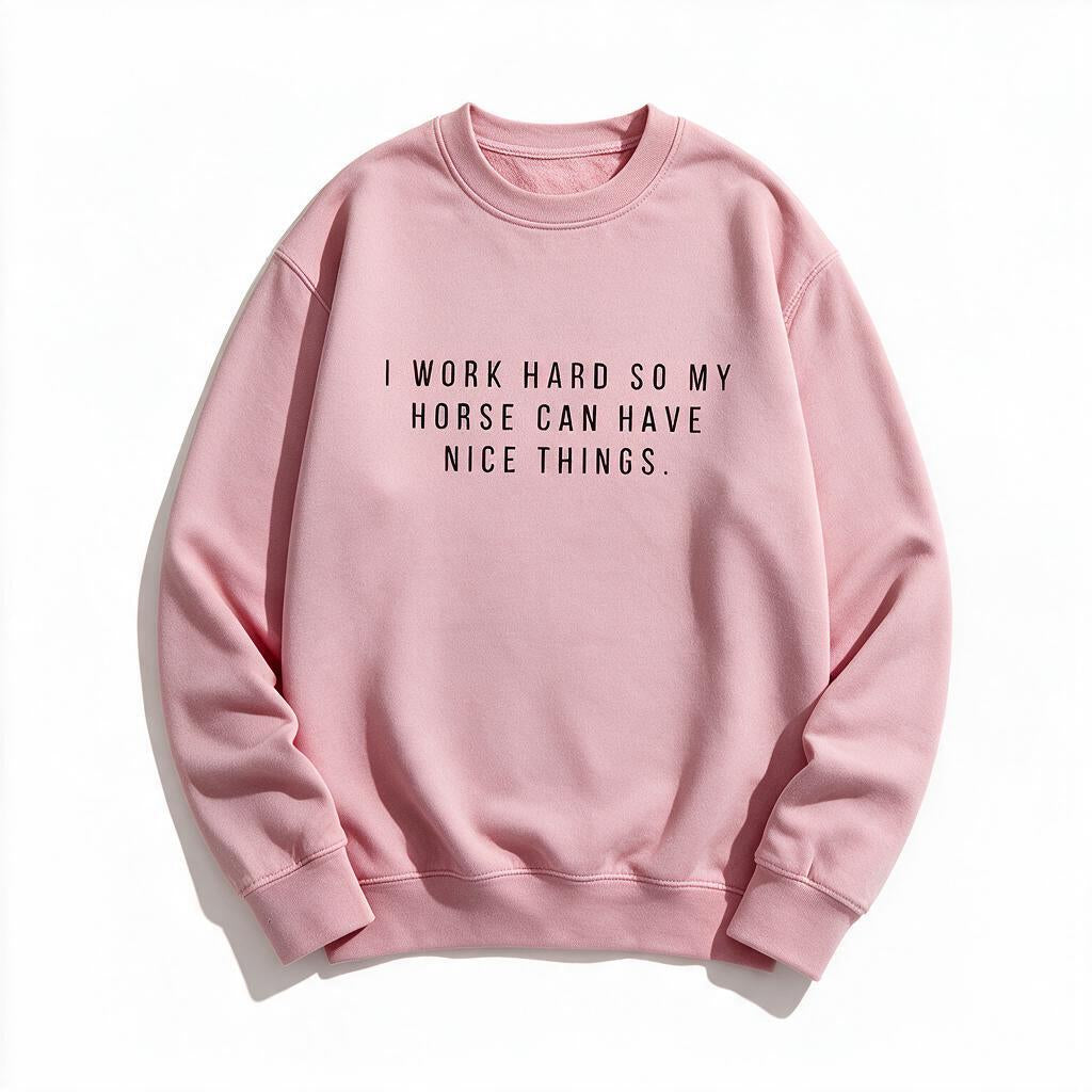 I Work Hard So My Horse Can Have Nice Things sweatshirt in light pink, flat lay on white