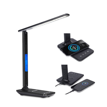 LED desk lamp wirelessly charging a phone on its base