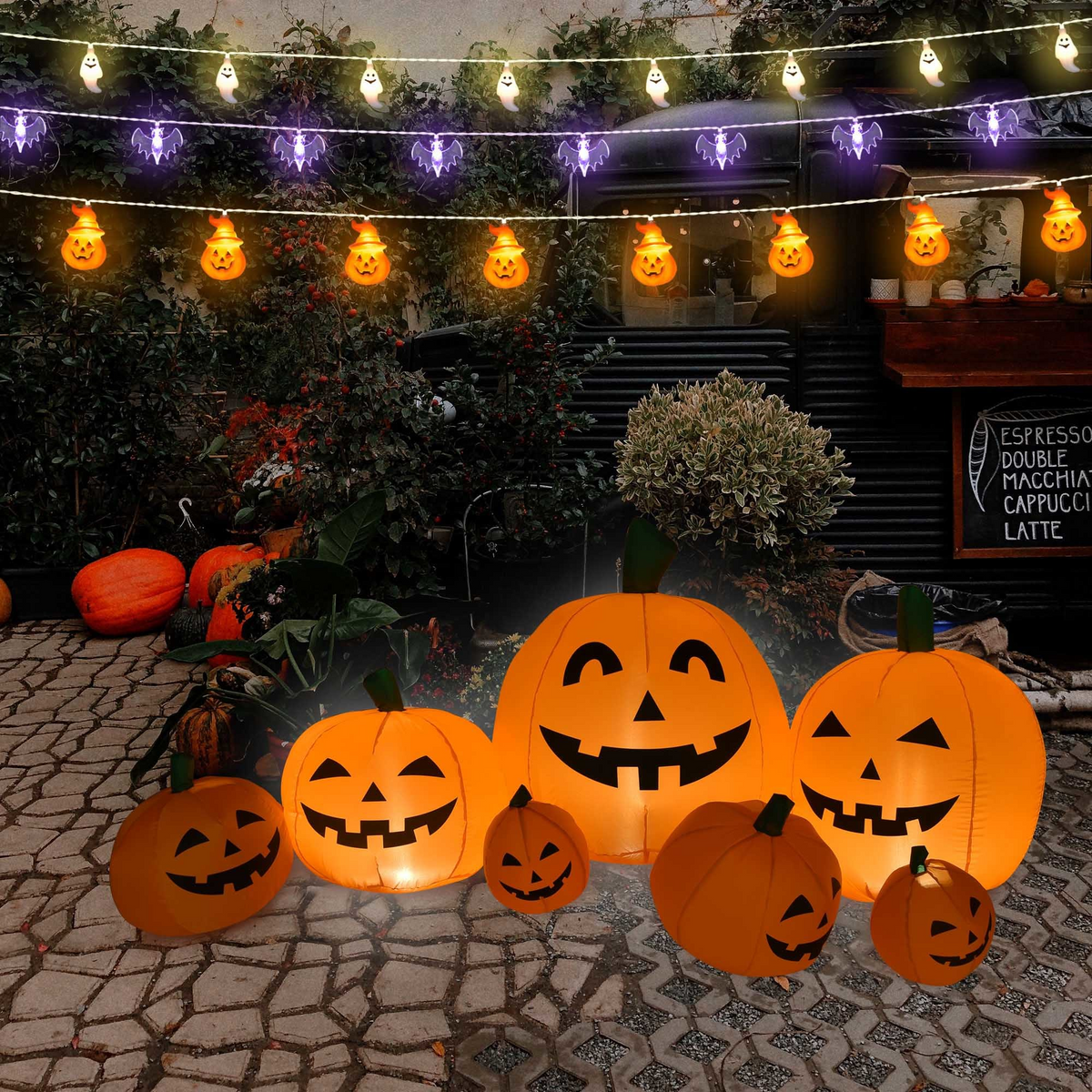 Pumpkin string lights over a patio with glowing jack-o-lanterns