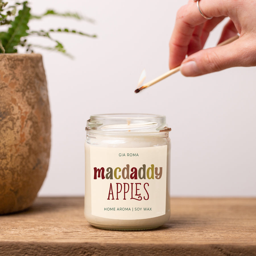 Lighting the Macdaddy Apples soy candle with a match