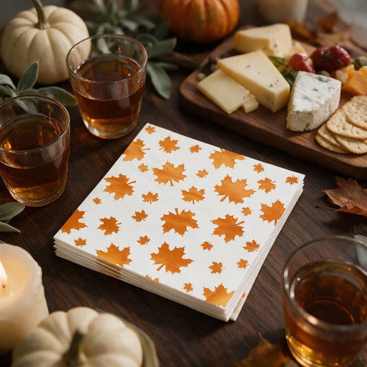 Stack of orange foil maple leaf cocktail napkins on a Thanksgiving appetizer table