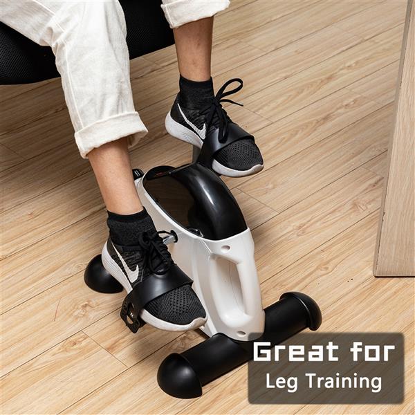 Feet pedaling the mini exercise bike under a desk for leg training