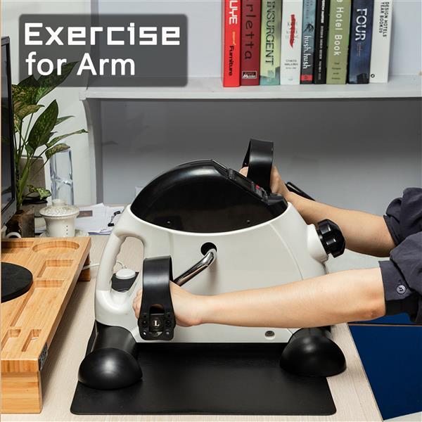 Arms pedaling the mini exercise bike on a desk