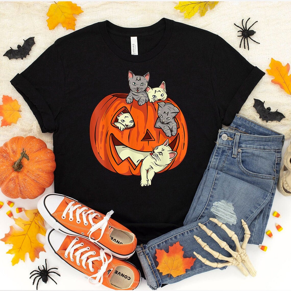 Black pumpkin cat Halloween t-shirt styled with jeans, orange sneakers and Halloween decorations