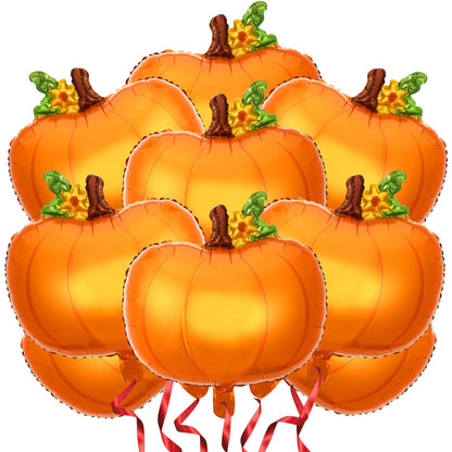 Orange pumpkin foil balloons with green stems and red ribbons on white
