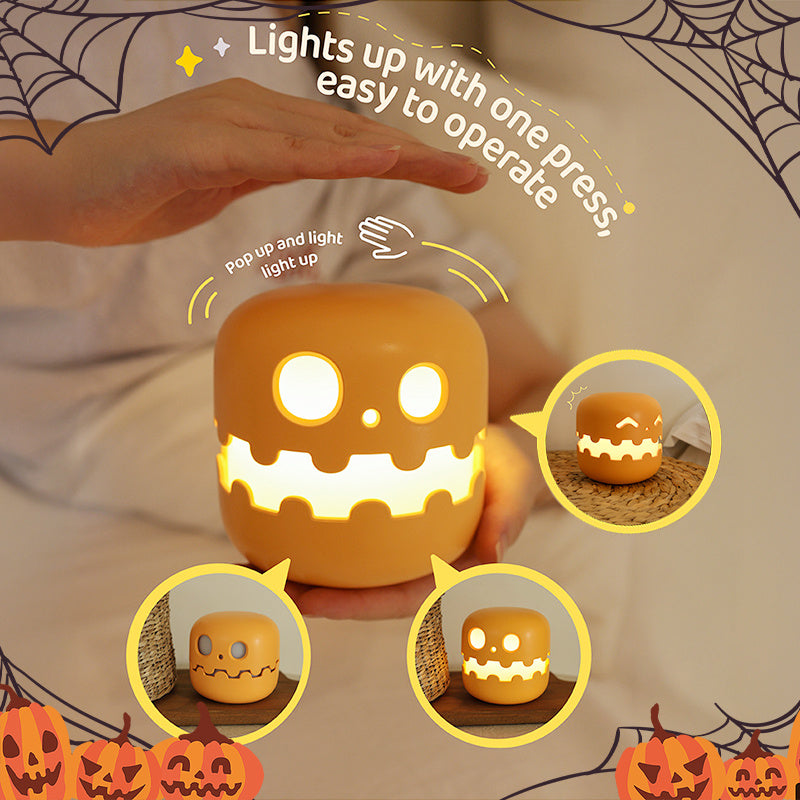 Pumpkin silicone night light that lights up with a press of the top
