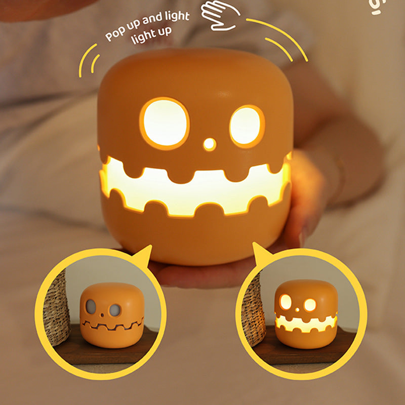 Pumpkin silicone night light in a hand, with press-to-light close-ups