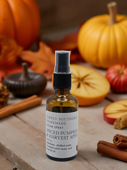 Spiced Pumpkin and Harvest Apple room spray on a wood table with sliced apples, pumpkins and cinnamon sticks