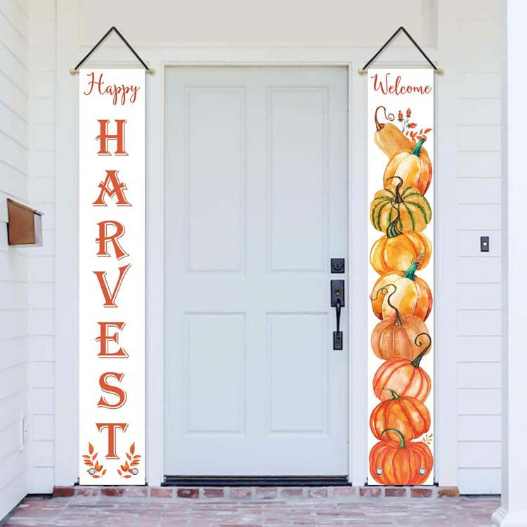 White Happy Harvest and Welcome pumpkin banners beside a white front door