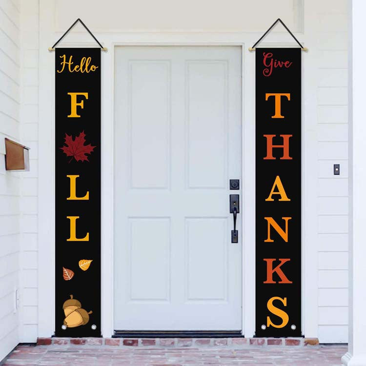 Black Hello Fall and Give Thanks banners beside a white front door