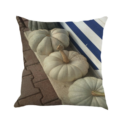 Pillow cover printed with white pumpkins on a porch step